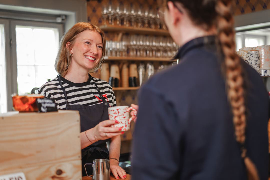 Female shopowner, coffeeshop, smiles